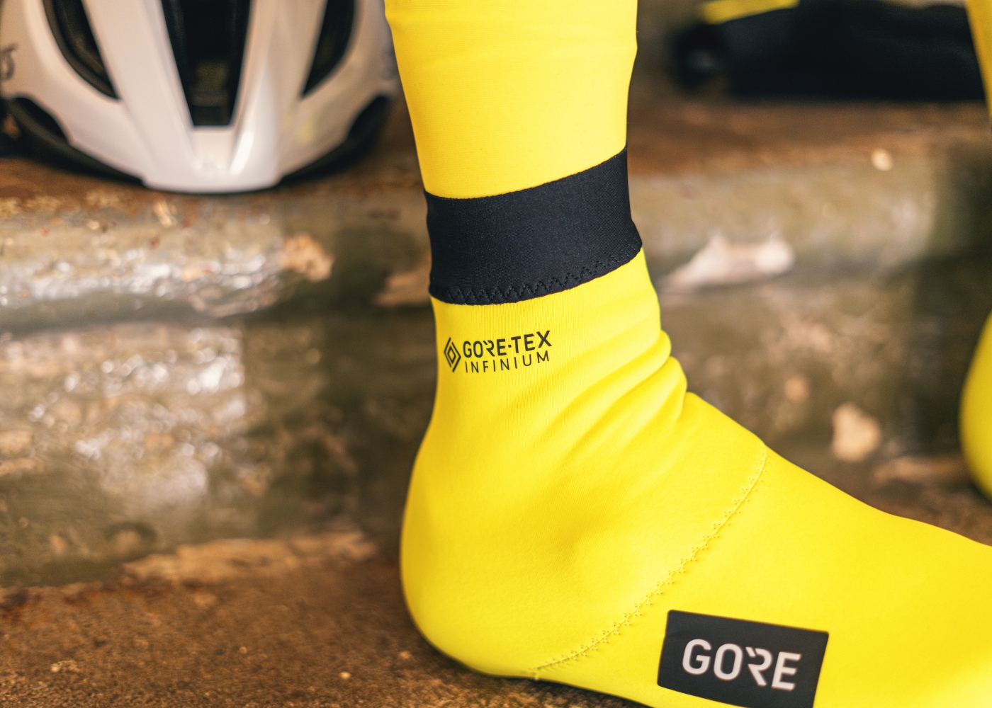 Close-up of a person putting on neoprene overshoes for road cycling