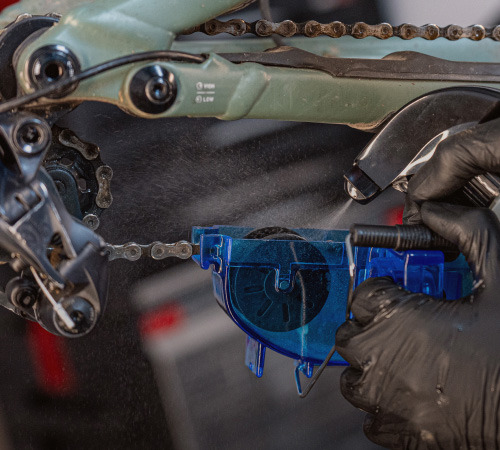 Close-up of a bicycle chain being cleaned