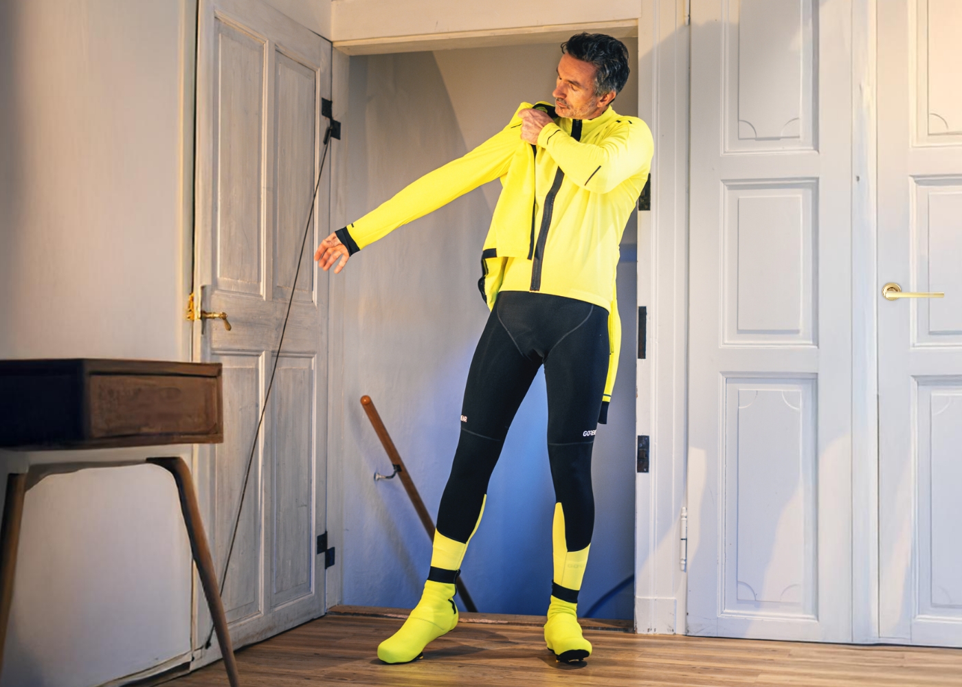 A man puts on road bike clothing for a winter ride.