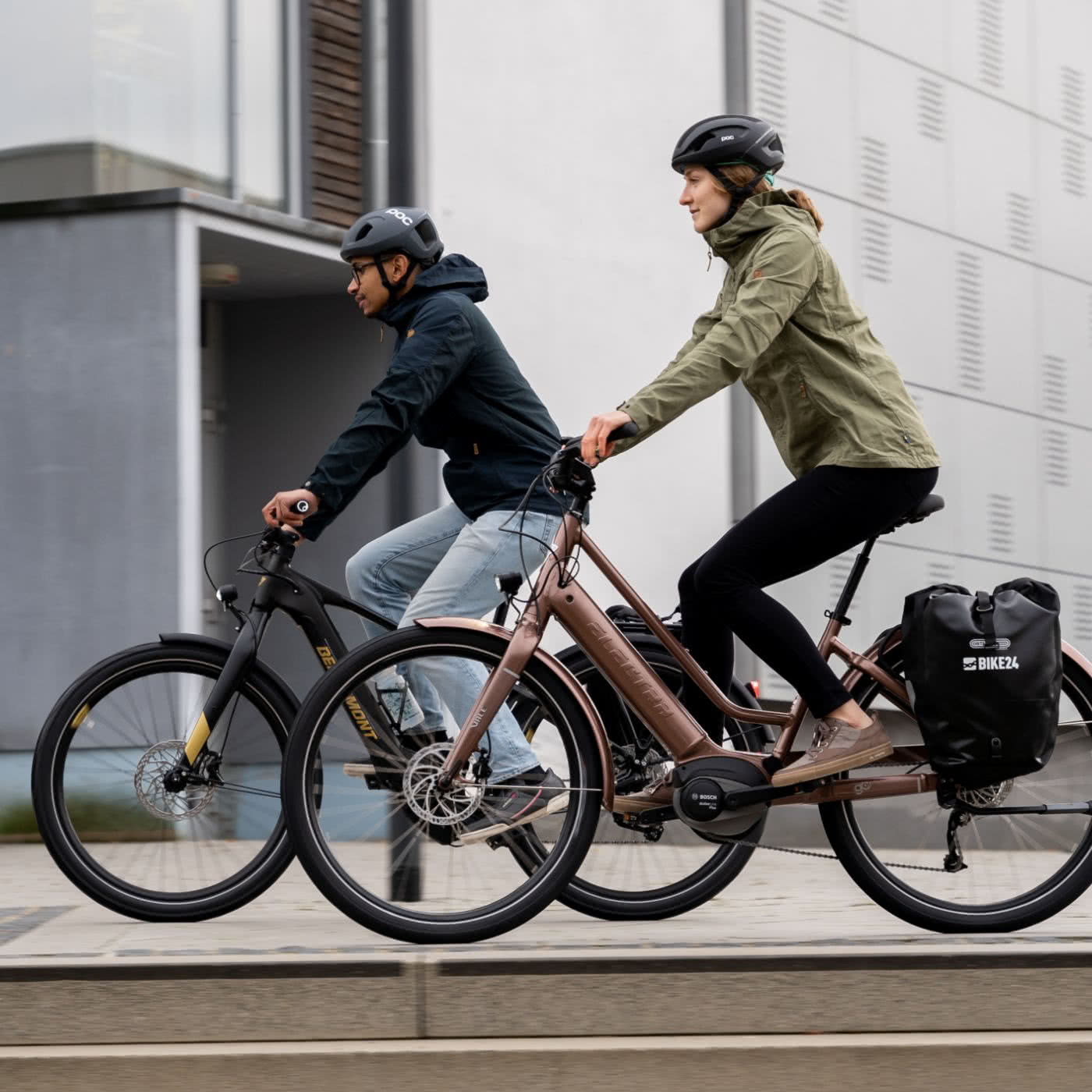 Man and woman on e-city bikes