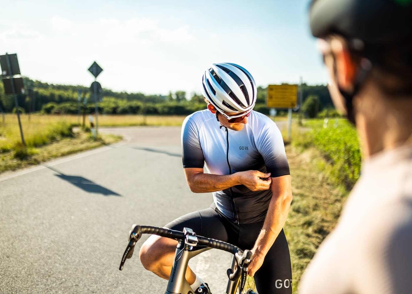 A road cyclist is looking at his summer jersey fabric.